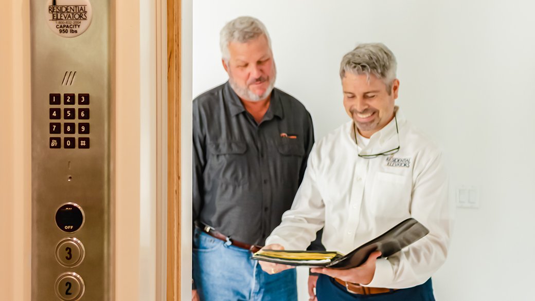 Going over the checklist for a residential elevator.